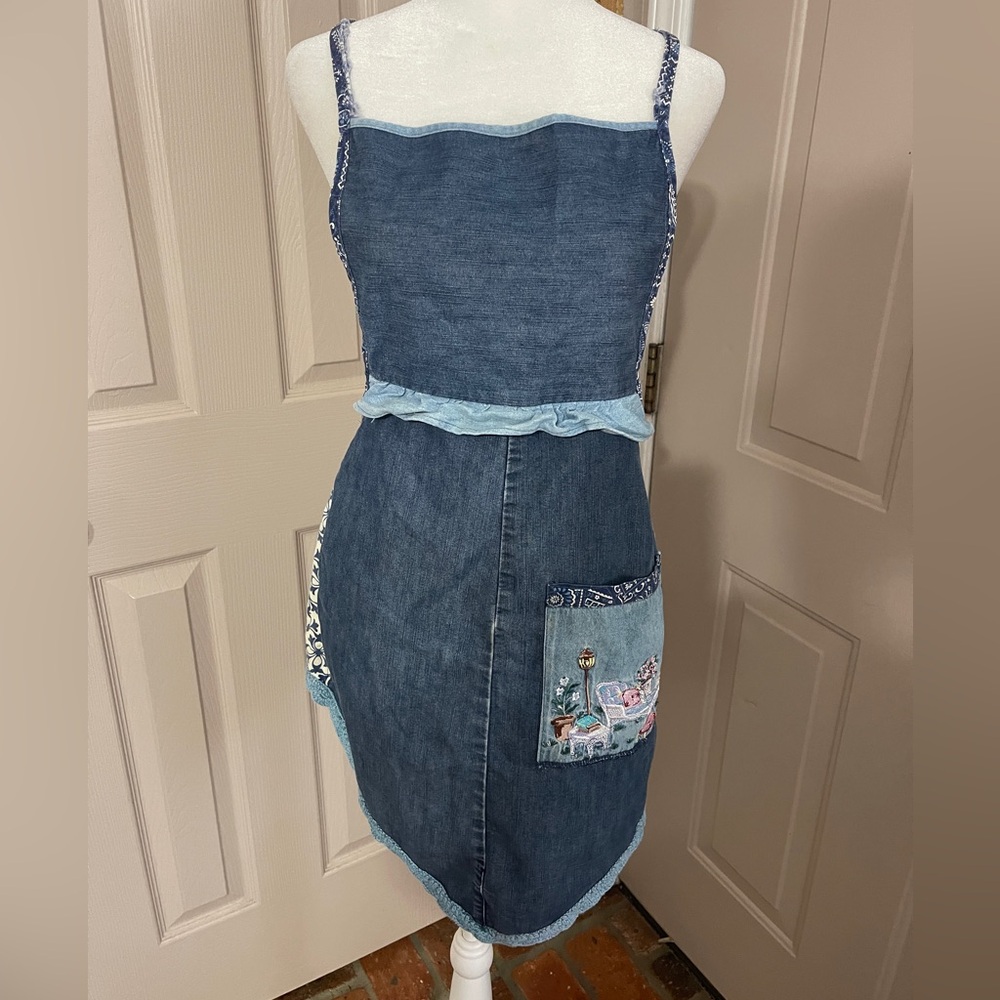 Vintage medium wash light weight ruffled denim apron with embroidered pocket.